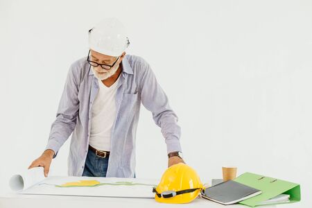 Senior professional architecture building engineer looking at blueprint floor plan serious workingの写真素材