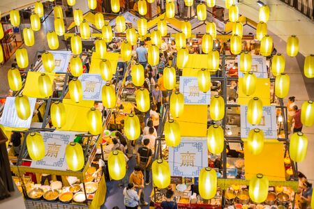 Vegetarian Festival (J Festival) In Thailand Shopping Mall vegan food stall decoration with yellow flag and lots of people Thai and Chinese. 29 September 2019. Chiang Mai, THAILAND.のeditorial素材