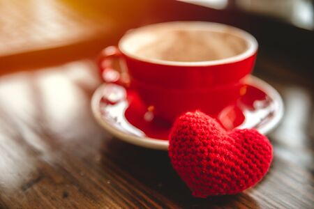 Coffee cup with red heart for love to drinking coffee or meeting date at cafe concept.の写真素材