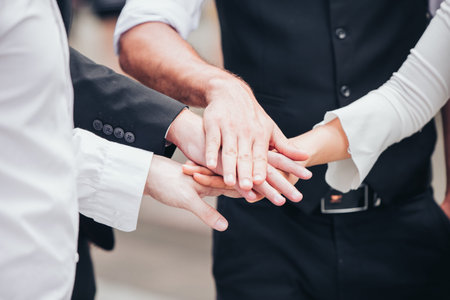 Business people join hand together for unity teamwork or partner concept.