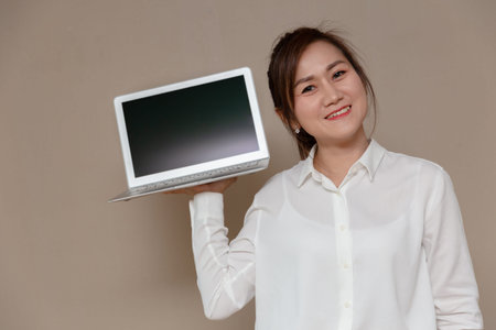 Asian woman smiling single handle computer laptop for new thin and light weight laptop computer.の写真素材