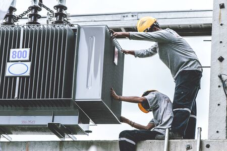 technician or electricity engineer working setup replace new electricity current transformer size 800kVA for condominium.の写真素材