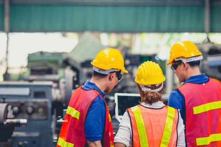 engineer team mix race working together in heavy industry with laptop computer discussion, join...
