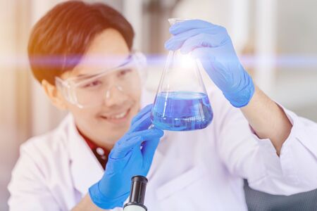 Scientist happy to successful discover new anti virus drug formula chemical liquid in hospital medical science labの写真素材
