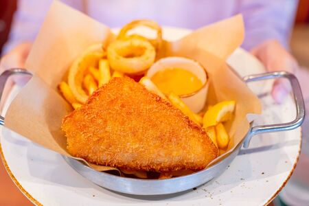 Delicious tasty look crispy fish and chip with dipping sauce fatty deep fried western food menuの写真素材