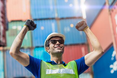 Happy Winner worker, Foreman shipping dock staff working at Container cargo harbor Rising hand for Win in Business Logistics.の写真素材