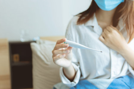 Closeup people using thermometer takes body temperature for diagnosing flu and fear to Coronavirus...