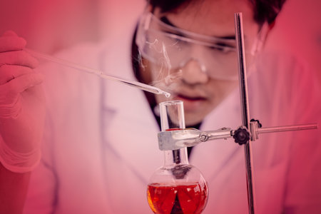 Young Asian scientist testing carefully of terrible danger and risk chemical formula or virus in...