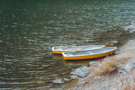 Two wooden boat with no people in quiet lake, no traveller and tourist  impact of Coronavirus(COVID-19) outbreakの写真素材