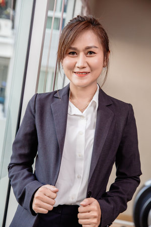 Business Southeast Asia Thai woman adult 40s standing confidence smiling with dressing suite...