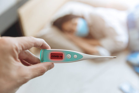 closeup hand show Coronavirus flu detector device display show results and identify Covid-19...