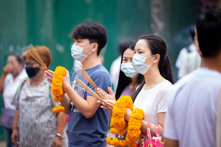 People buying vegan food sale only during Vegetarian Festival (J Festival) In Thailand at Yaowarat or Bangkok China town decoration with yellow flag for No animal meat food sign. 18 October 2020のeditorial素材