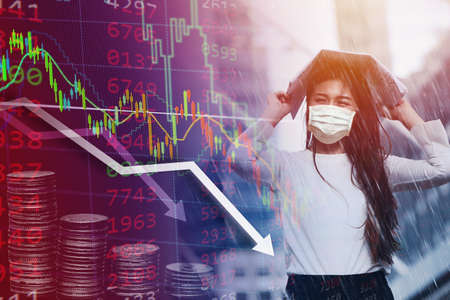 Girl in the heavy rain storm cover head with newspaper for economic obstacle passing concept.の写真素材