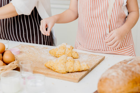 People at home bakery making homemade butter croissants.