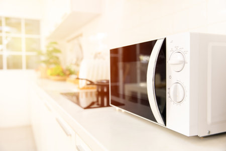 Kitchen counter closeup microwave oven cooking machineの写真素材