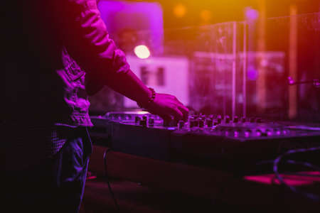 professional stage sound mixer closeup at sound engineer hand using audio mix slider working during concert performanceの写真素材