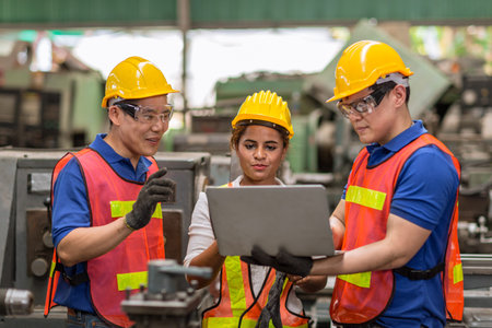 engineer women working with male team mix race work help together in heavy industry with laptop...
