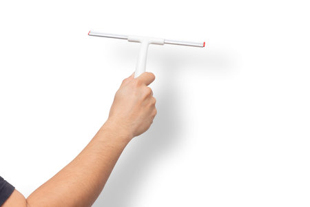 Male hand with Windows Glass Wiper Cleaner Squeegee Car Windshield Glass Blade isolated on white...