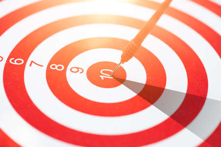 high performance precision red dart arrow hit the center target highest score of dartboard. Business management and planing straight to success go winner goal concept.の写真素材
