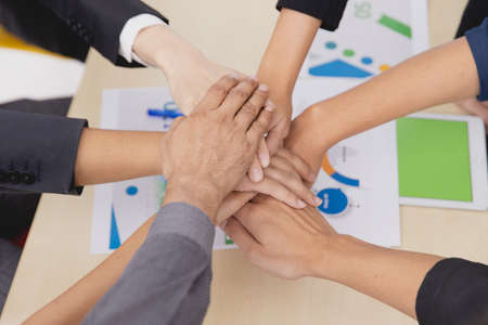 Closeup topview businesspeople join hand together.Stack of people hands. Unity and Team Teamwork Empower business worker for company concept.の写真素材