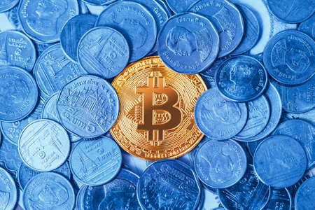 Bitcoin crypto digital currency around with physical coin money Thai Bath.の写真素材