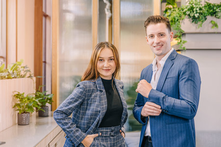 Portrait caucasian business man and women standing together in modern office with British suit...