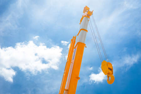 Hoist crane yellow hook head construction truck clean new with blue sky cloud background.の写真素材