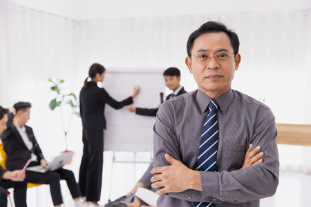 Portrait Asian adult smart businessman confident arm crossed. Business owner male standing with...