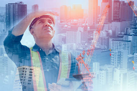 Foreman engineer builder overlay with metro urban for vision of land development city construction conceptの写真素材
