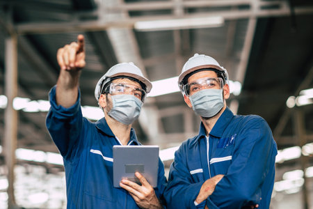 Engineer worker men teamwork wear face mask during service working in factory to check prevent virus...