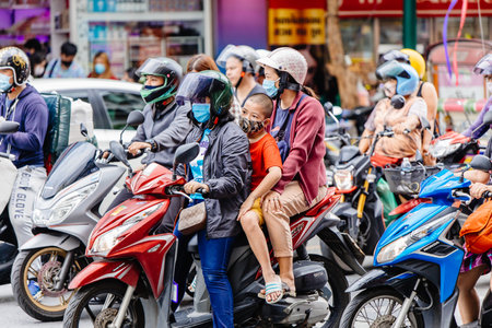 Traffic jam in Bangkok, Rider people and kid drive on the road with waring face mask for prevent Coronavirus and protect bad air pollution. 30 May 2020, Bangkok, THAILAND.のeditorial素材