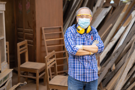 Portrait of elder wood worker hobby for good retirement, Asian male mature professional master of wood craft furniture wooden maker man.の写真素材