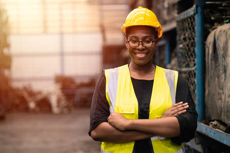 Portrait Black smart African women worker standing happy smiling in factory industry workplaceの写真素材