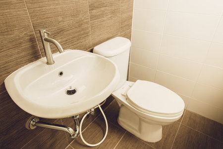 Hand wash basin and toilet bowl in the home bathroom.の写真素材