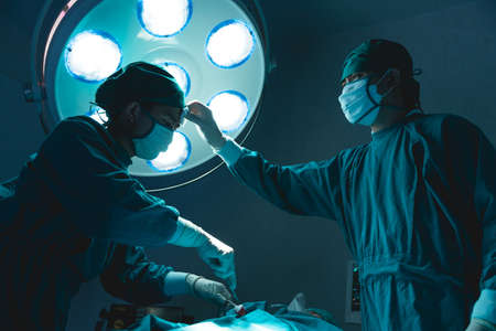 doctor team hard working in operating room attempt to save patient life tried and exhaustedの写真素材
