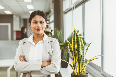 portrait Asian business women confident standing arm crossing happy smile office windowsの写真素材