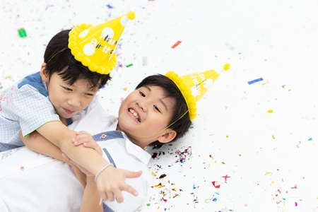 happy Asian kids enjoy playing together at the party with space for textの写真素材