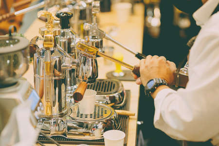Cafe barista using manual lever espresso coffee extractor hand press machine classy styleの写真素材