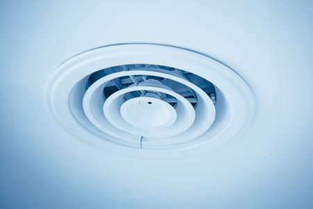 Air ventilation cover round ducting ceiling hole. air vent grille flow louver in large building blue...