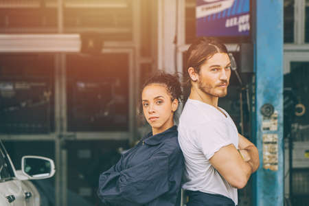smart portrait garage car mechanic staff worker man and women arm crossedの写真素材
