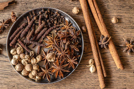 Assorted dry herbal mix indian spice herb natural meditation on wood backgroundの写真素材