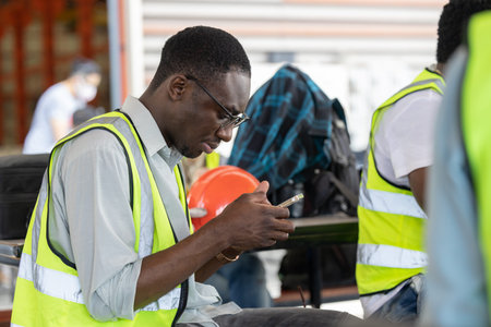 African Black worker relax playing mobile smart phone at lunch brake time rest happy smile.