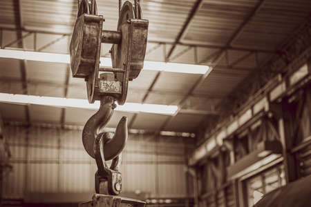 Hoist crane hook in factory warehouse brown vintage color toneの写真素材