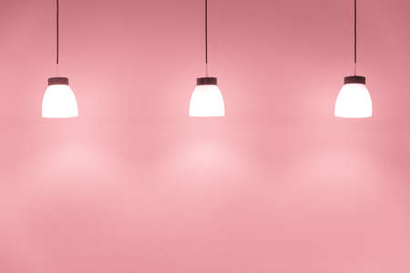 ceiling drop down light decoration on sweet pink wall for interior lighting backgroundの写真素材