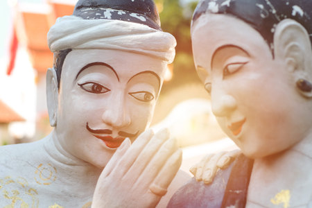 Love whispering man to women couple lover statue legend story landmark of Nan province, July 2020....