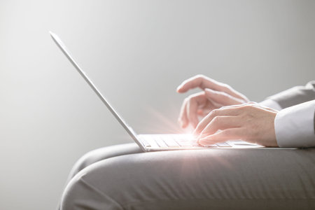 Businessman typing on laptop computer high performance ultra thin and light weight on lap with work...