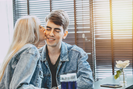 young couple lover kissing together, cheek kiss love expression at public space.