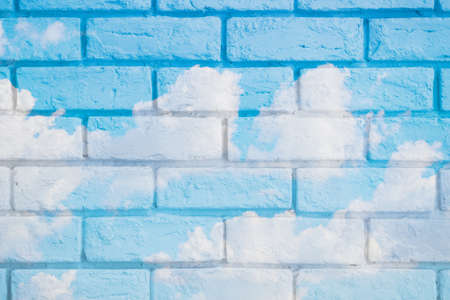beautiful blue sky overlay with brick wall for postcard backgroundの写真素材
