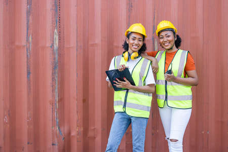 African teen black woman staff worker teamwork in port cargo shipping portait happy smileの写真素材