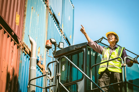 Asian senior elder worker working control load lifting cargo in transport shipping industry